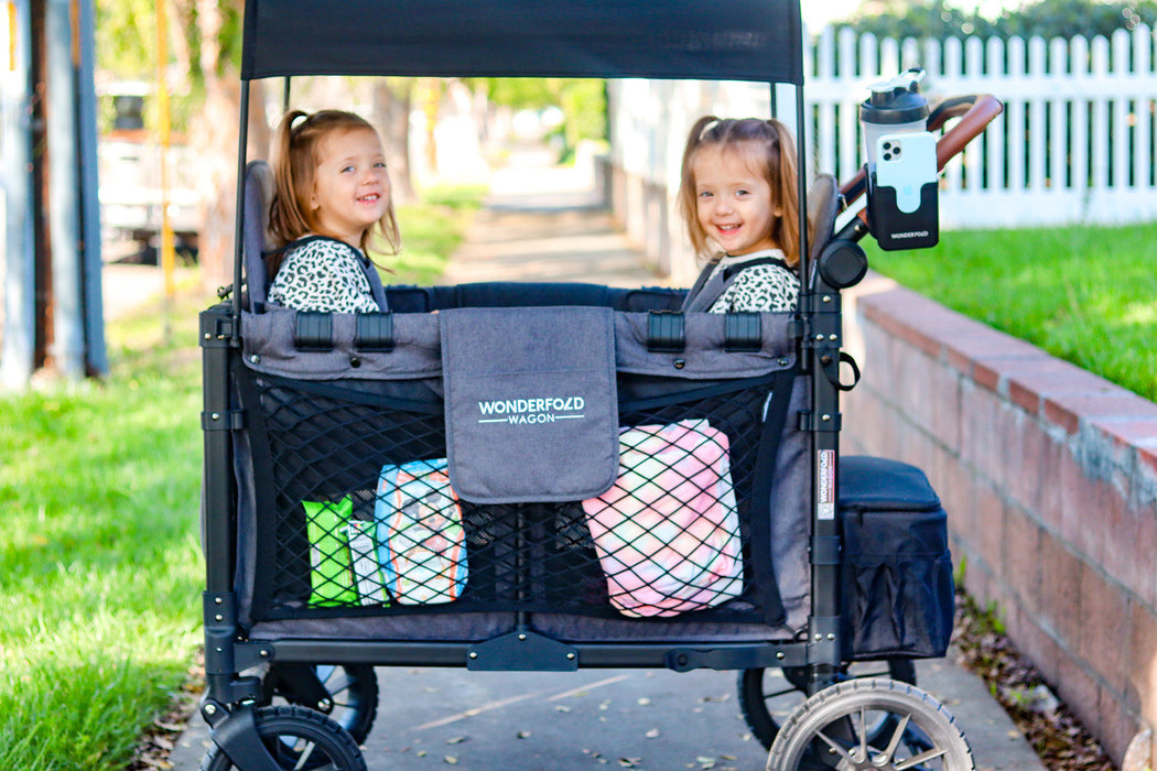 Two children sitting in a WonderFold Wagon